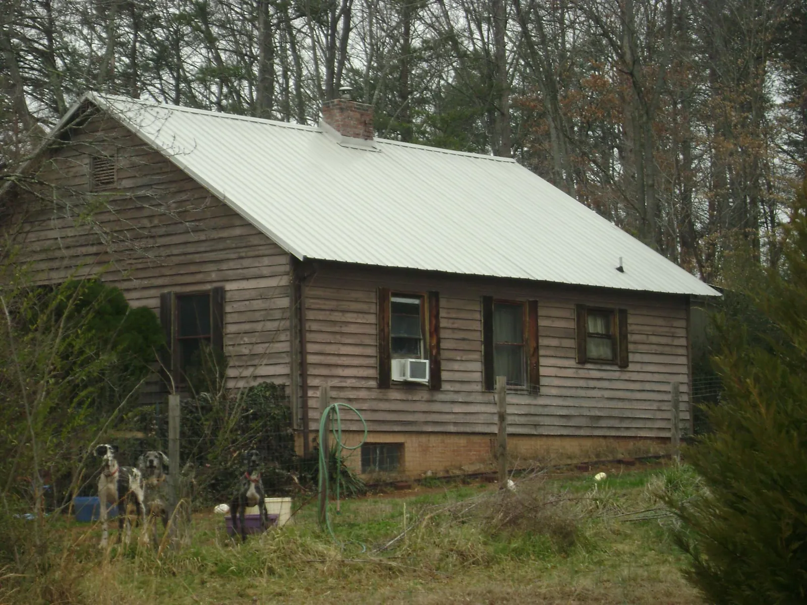 White metal roof on an old wood sided farmhouse, from a Metal Roof Installation job in Warrensburg